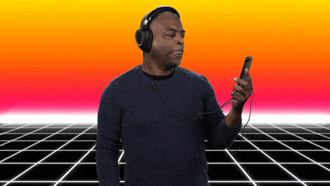 gif man with headphones on and looking at his phone with text saying you gotta hear this