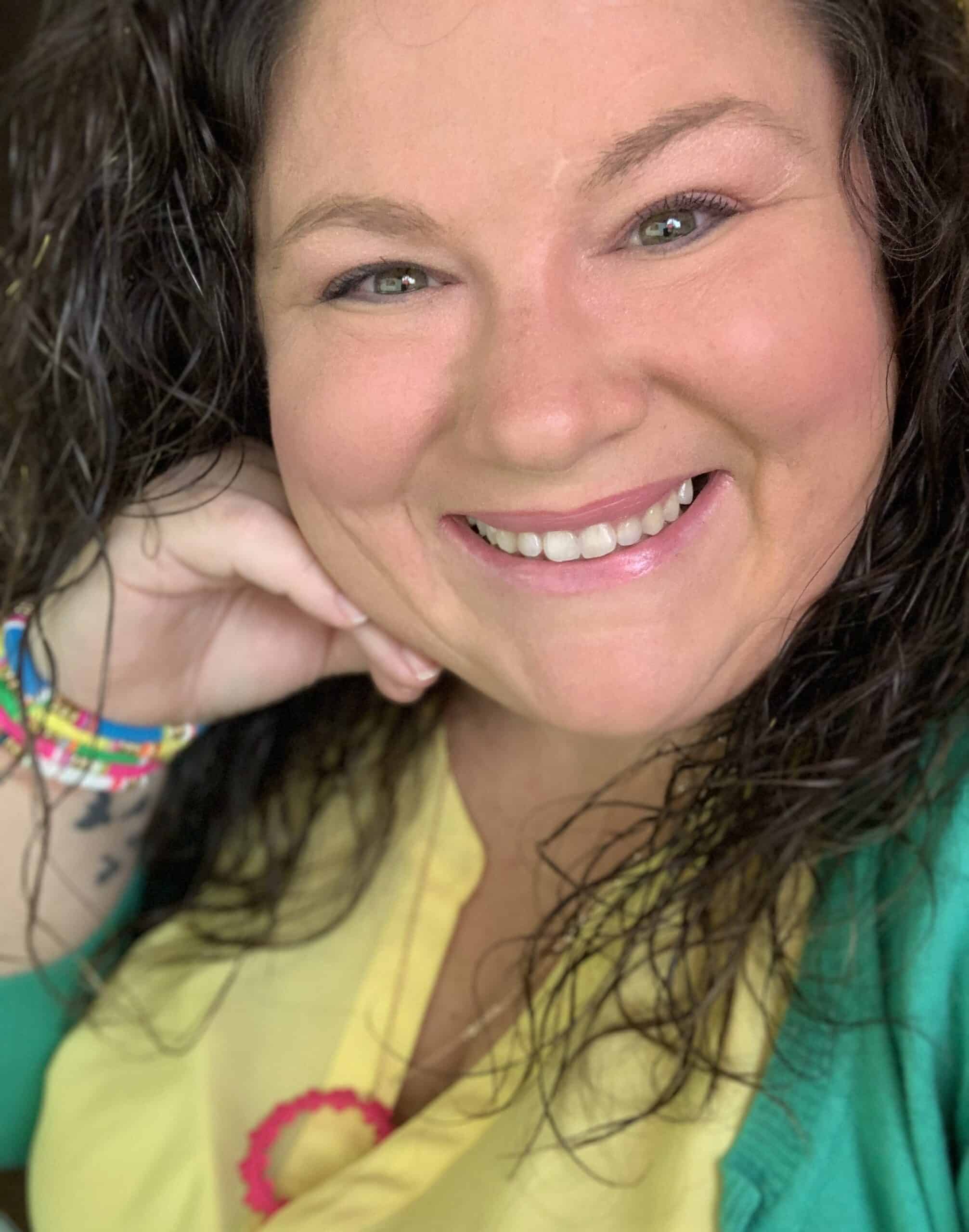 Tish 2022 A smiling woman with curly hair and a green shirt.